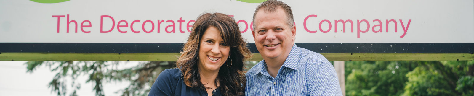  Pete Hess and Tina Corso-Hess, Corso's Cookies owners in front of their business sign.