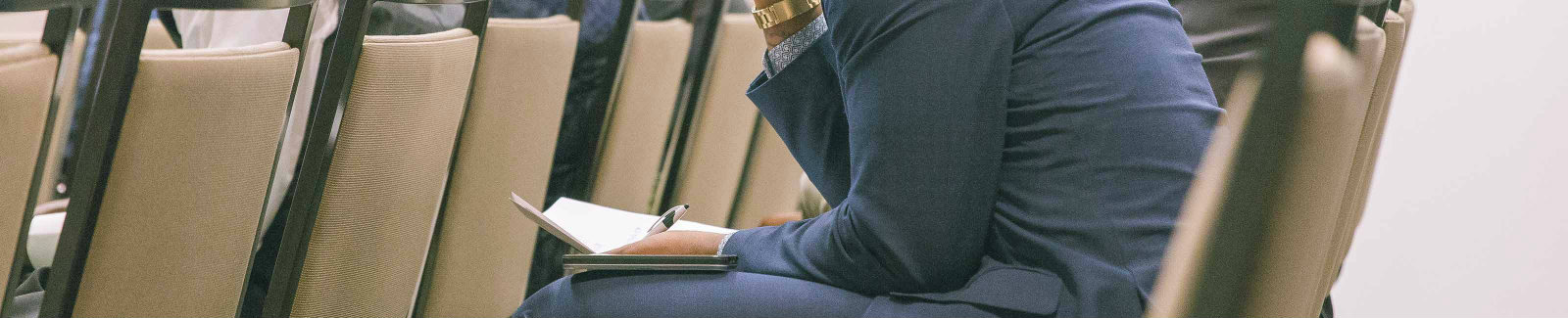 male in a suit listening intently to a financial workshop that was hosted by Bankinter S.A.