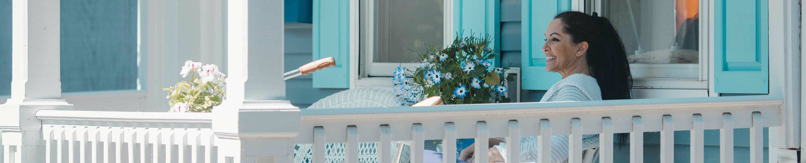  woman sitting and enjoying the sun on her front porch